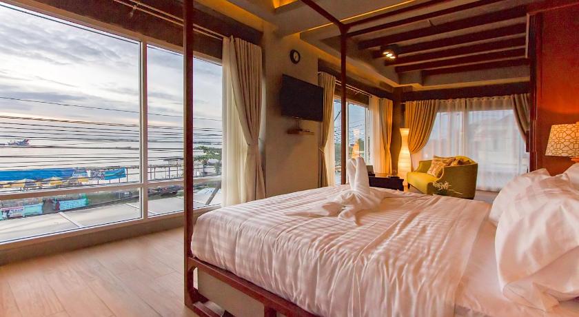 a hotel room with a bed and a window, Kroque Boutique and Bistro Hotel in Chonburi