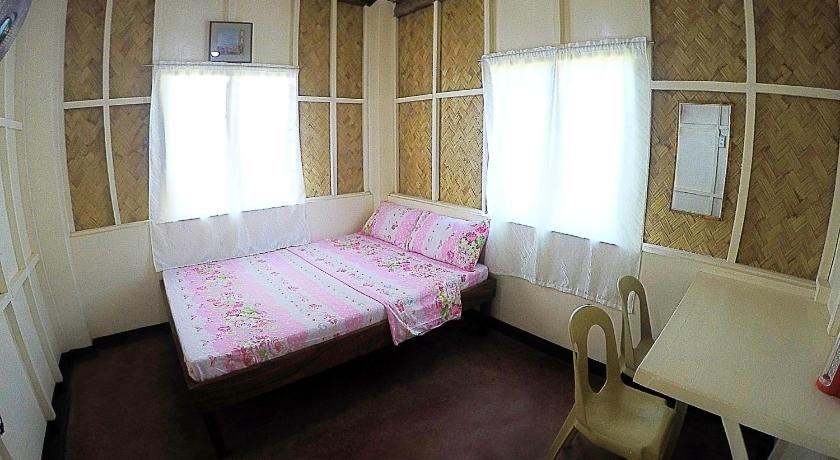 a bedroom with a bed and a window, RB Transient House in Palawan