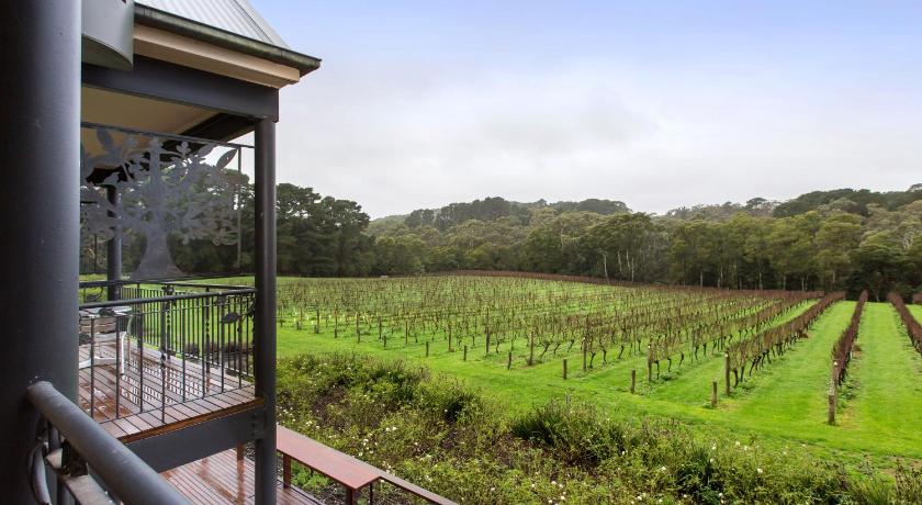 a train yard with a fence and trees, Mantons Creek Estate & Lodge in Mornington Peninsula