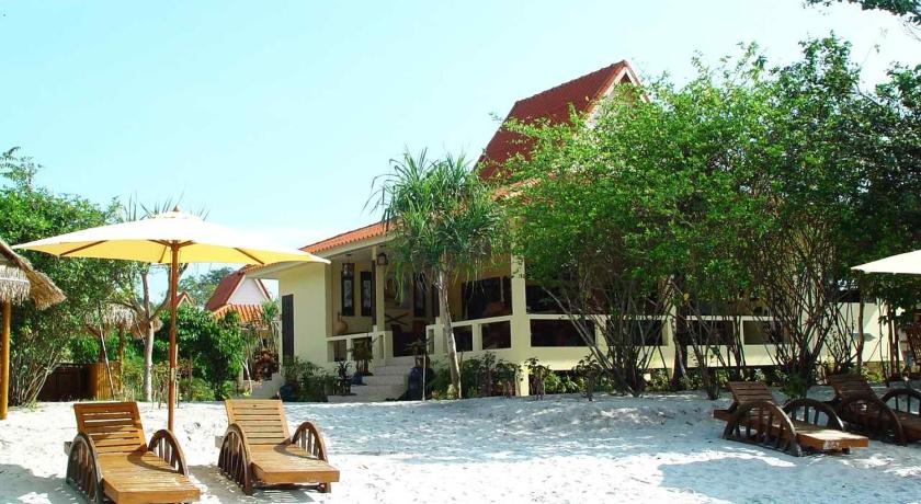 a beach area with a beach umbrella and chairs, Buffalo Bay Vacation Club in Koh Phayam (Ranong)