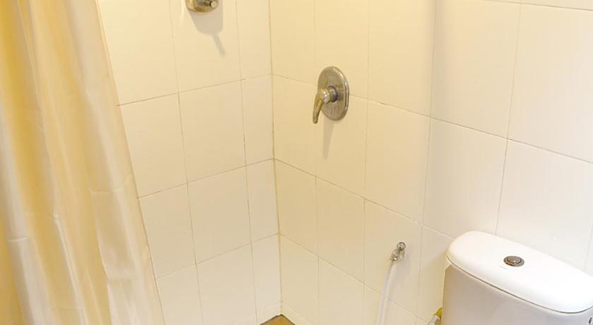 a bathroom with a toilet and a shower stall, Garden Inn Hotel in Penang