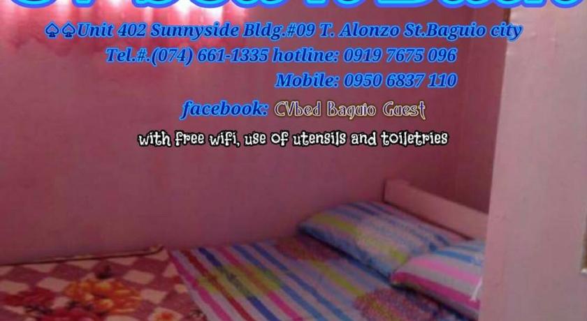 a bed room with a blue and white striped bedspread, CV bed n bath in Baguio