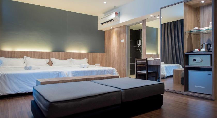 a hotel room with two beds and a television, Mornington Hotel Soon Choon Ipoh in Ipoh