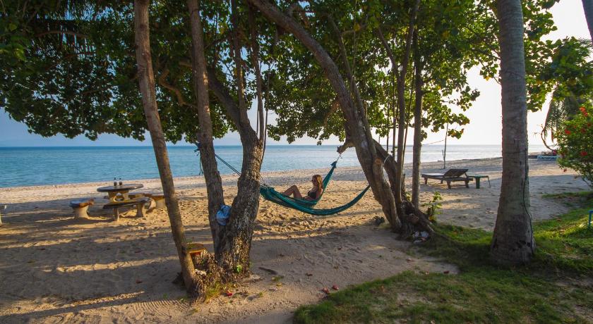 a beach scene with a person on a surfboard, Morning Star Resort in Ko Pha-ngan