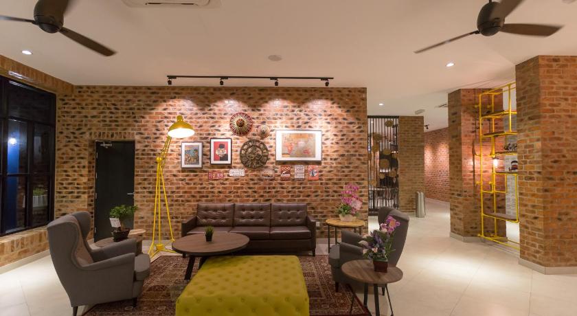 a living room filled with furniture and a fire place, Athome Boutique Hotel in Bintulu