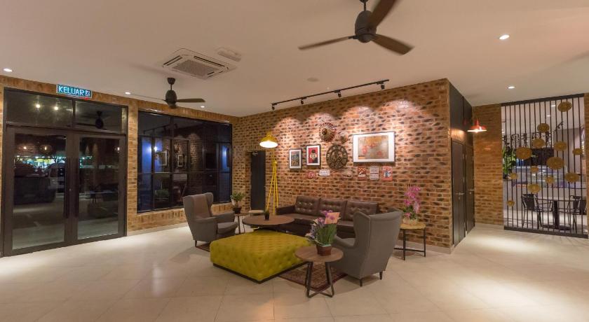 a living room filled with furniture and a fireplace, Athome Boutique Hotel in Bintulu