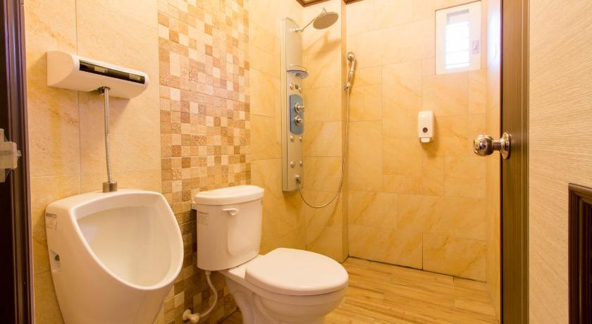 a bathroom with a toilet a sink and a shower, Alice Wonderland B&B in Yilan