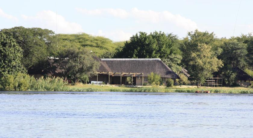 a large body of water with trees and houses, Big 5 Toro Lodge in Kasane