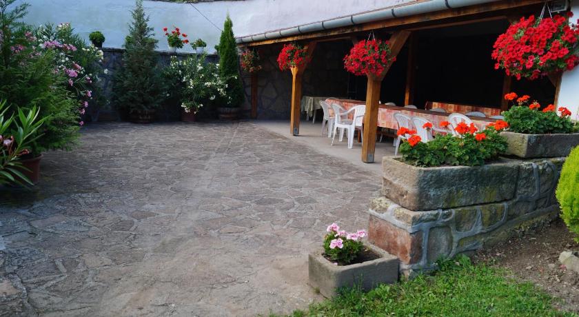 a garden area with a table and chairs, Cseresznyes Vendeghaz in Szomolya