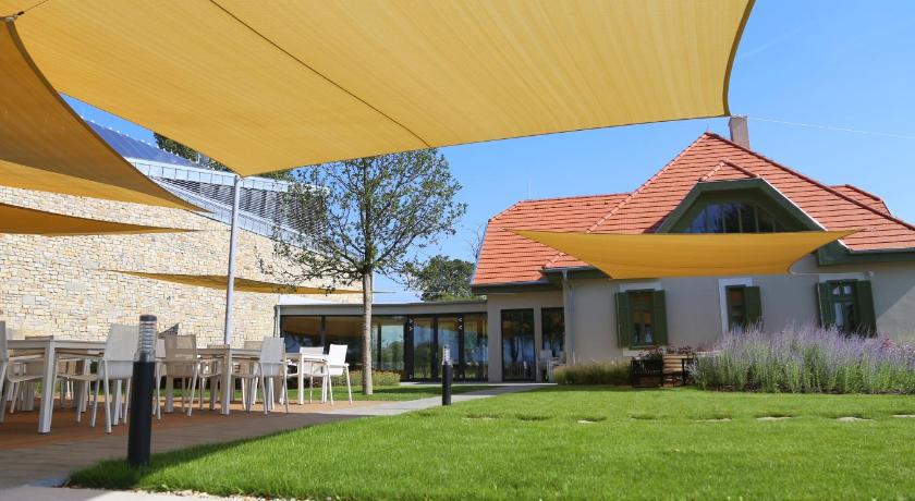 a patio area with umbrellas and lawn chairs, Fenyves Yacht Club Superior in Balatonlelle