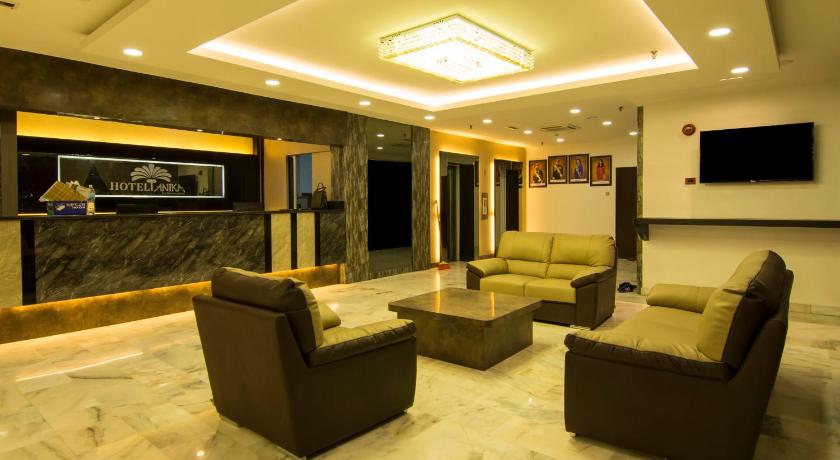 a living room filled with furniture and a large window, Hotel Anika in Kluang