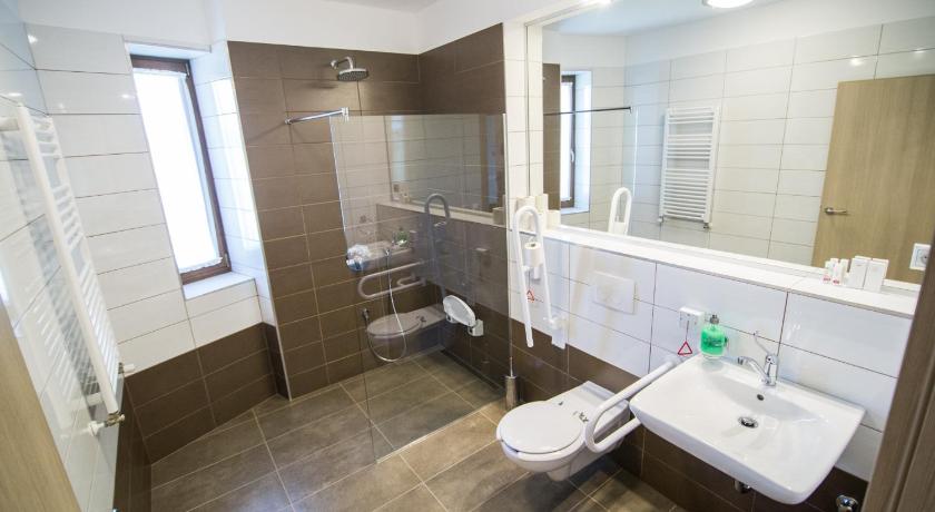 a bathroom with a sink, toilet and bathtub, Oregtolgy Guest House in Szár