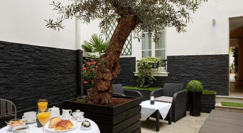a table topped with a tree next to a bench, Hotel Le Twelve in Paris