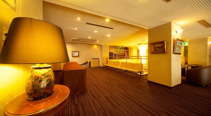 a living room filled with furniture and a tv, Kochi Sunrise Hotel in Kochi