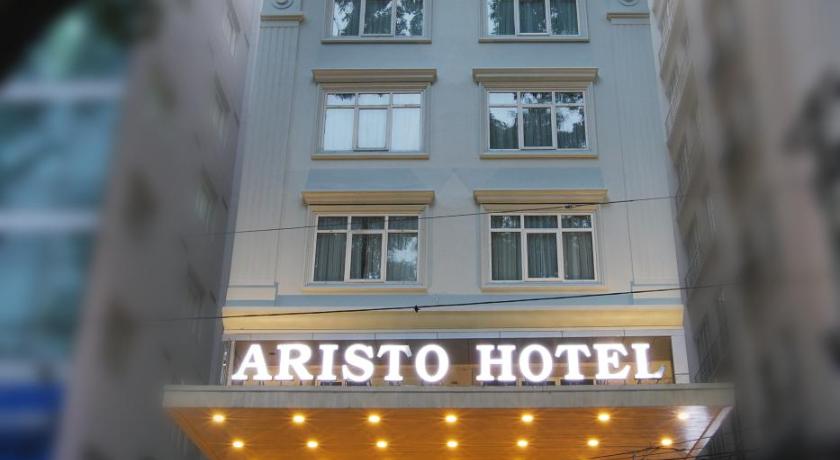 a large building with a clock on the front of it, Aristo Saigon Hotel in Ho Chi Minh City