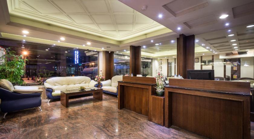 a living room filled with furniture and a large window, The Enterpriser Hotel in Taichung