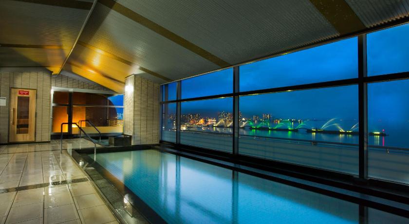 a large swimming pool in a large building, Biwako Hotel - Lakeside Hotspring Resort in Otsu