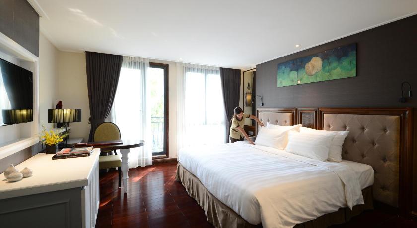 a hotel room with a large bed and a large window, The Chi Boutique Hotel in Hanoi