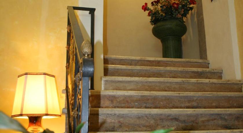 a staircase leading up to a room with a staircase, Hotel Posta in Orvieto