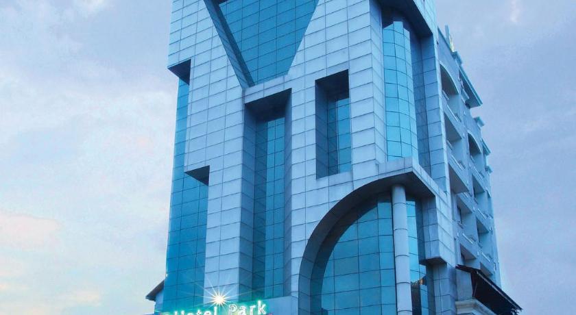 a large building with a clock on the front of it, Hotel Park Residency in Kochi