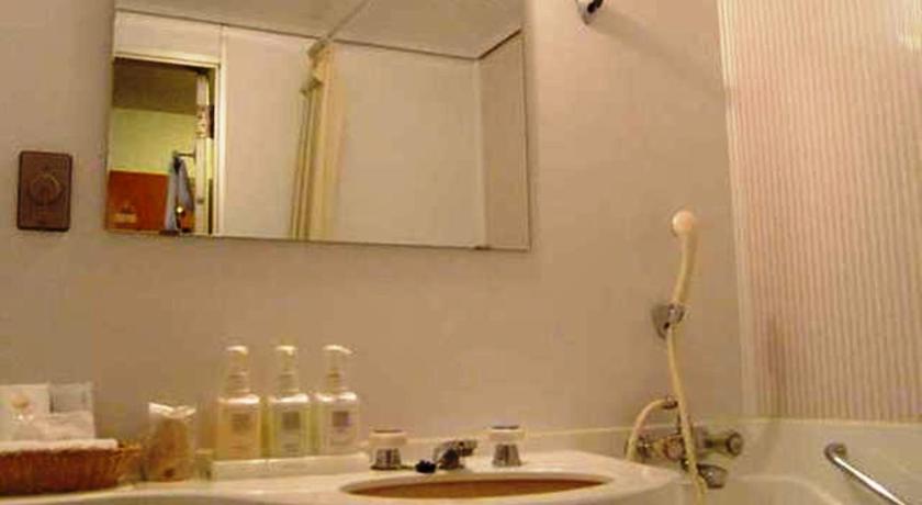 a bathroom with a sink and a mirror, Princess Garden Hotel in Nagoya