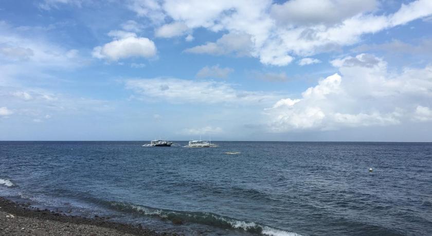 a large body of water with a beach, Sea Dream Resorts in Dumaguete