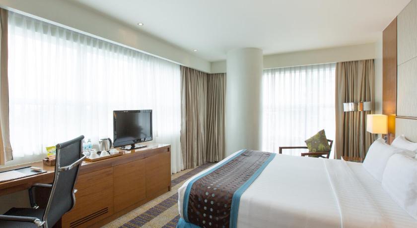 a hotel room with two beds and a television, Lex Hotel Cebu in Cebu