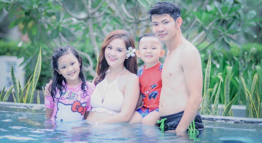 a family posing for a picture in the water, Green Boutique Villa in Hoi An