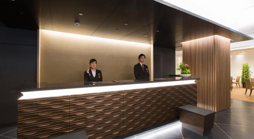 a man standing next to a woman in front of a counter, Urban Hotel Kyoto-Nijo Premium in Kyoto