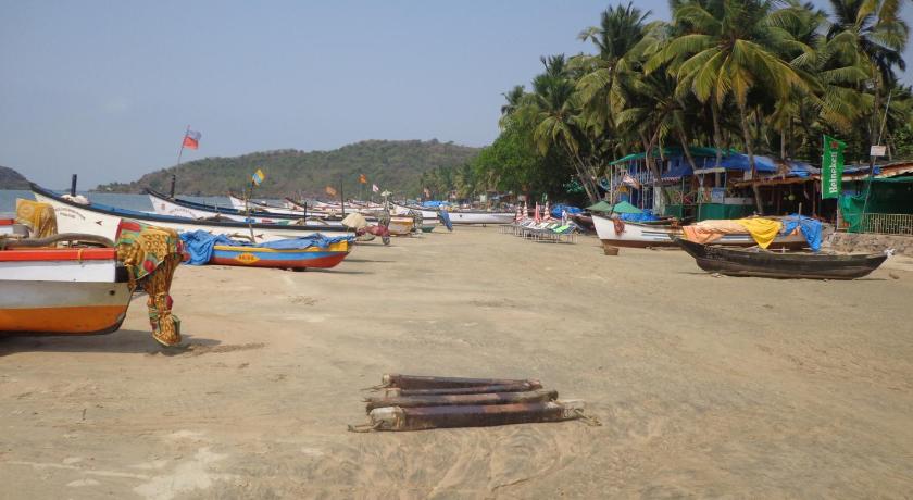a row of boats on the beach near a beach, The Tubki Resort in Goa