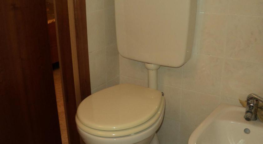 a white toilet sitting in a bathroom next to a sink, Gaeta centro in Gaeta