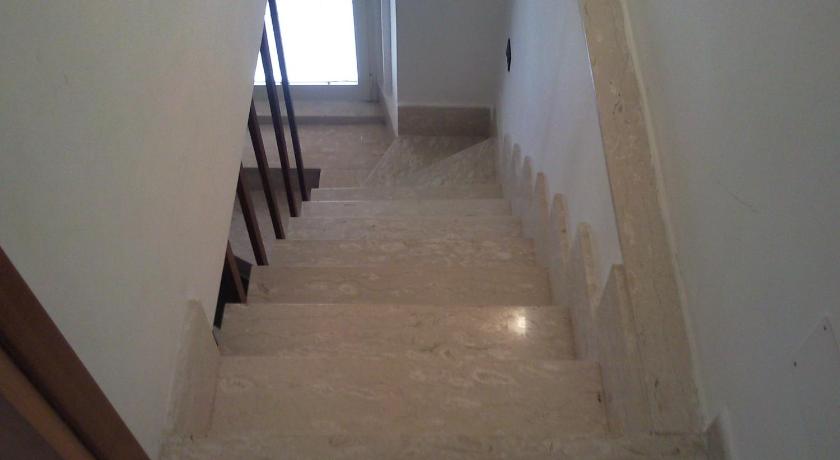 a row of stairs leading up to a room with white walls, Gaeta centro in Gaeta