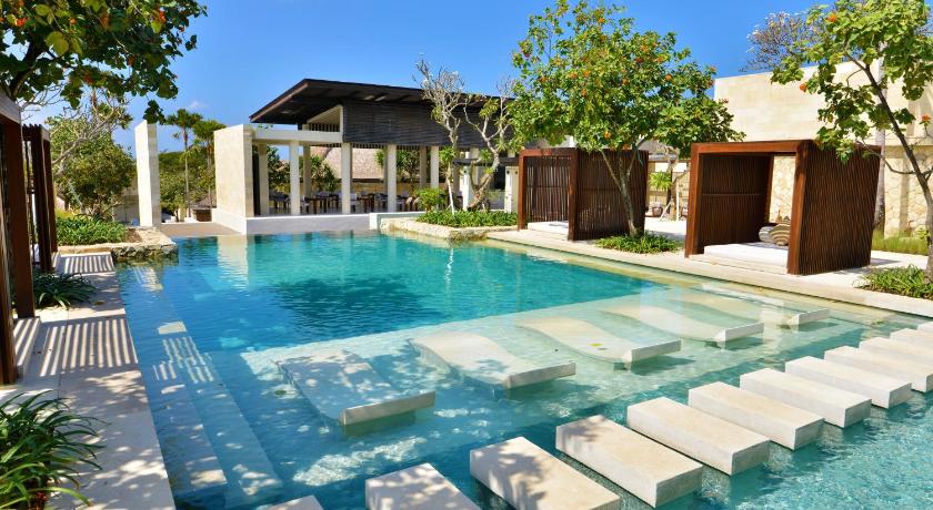 a pool with chairs and tables in it, The Bale Nusa Dua by LifestyleRetreats in Bali