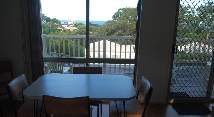 a dining room table with chairs and a window, Lookout Holiday Units in Lakes Entrance