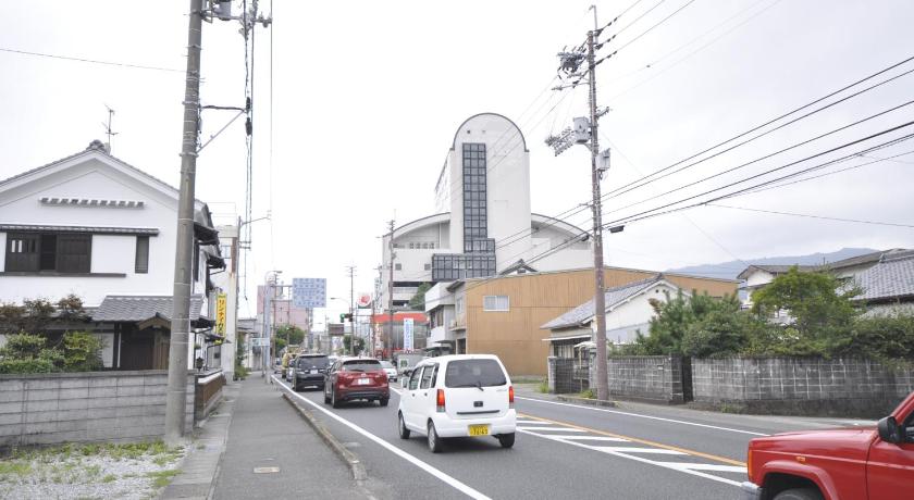 a truck driving down a street next to a building, Hotel Tamai in Muroto