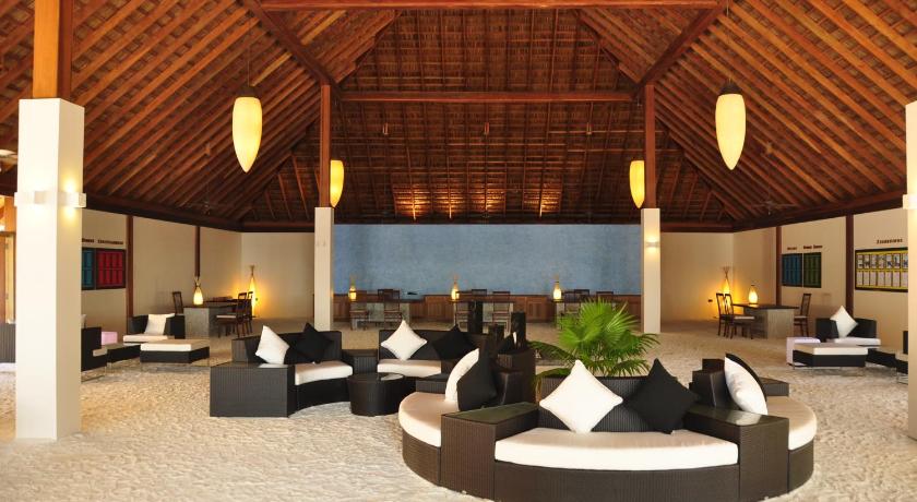 a living room filled with lots of furniture, Vilamendhoo Island Resort & Spa in Maldive Islands