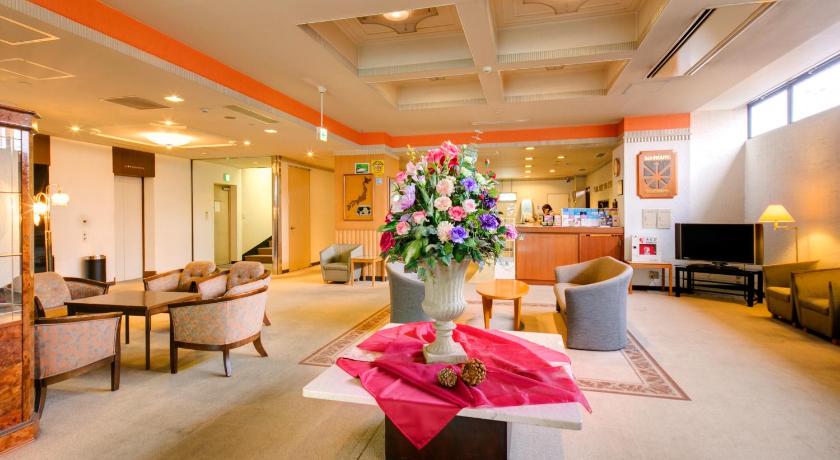 a living room filled with furniture and flowers, Hotel Sunroute Tochigi in Sano