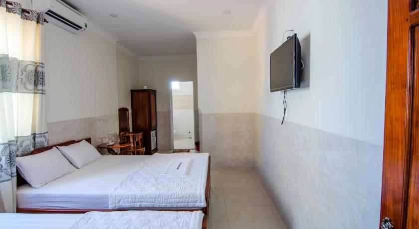 a hotel room with a couch and a television, Kim Hong Anh Guesthouse in Phu Quoc Island