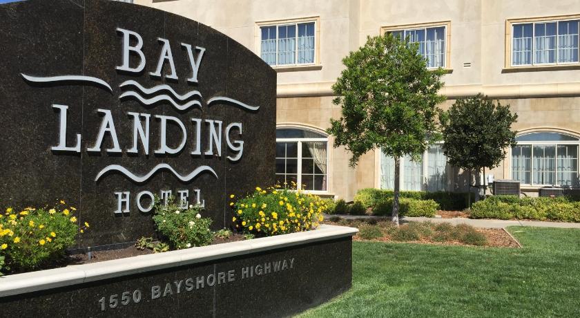 a large brick building with a sign on the side of it, Bay Landing Hotel in San Francisco (CA)