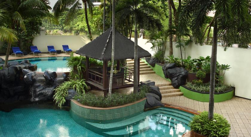 a patio with a pool, chairs, and a pool table, Ascott Jakarta in Jakarta