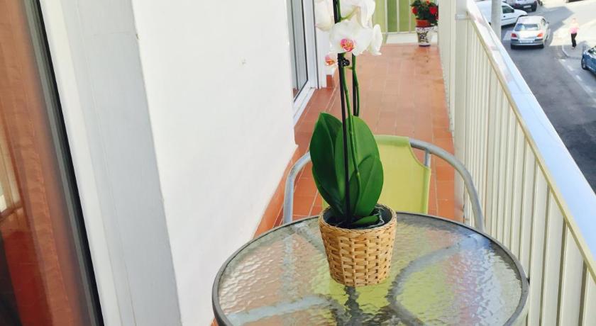 a green vase sitting on a table next to a window, Axarquia Apartments in Nerja