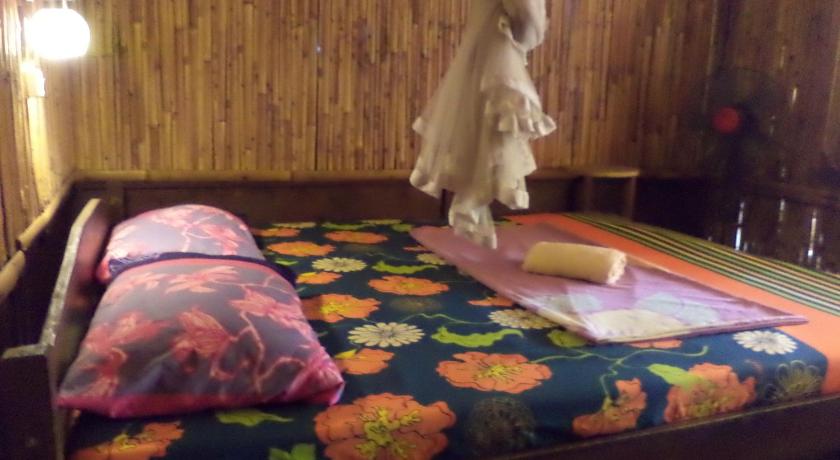 a person laying on a bed in a room, Topi Inn in Bali