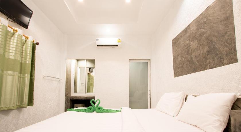 a bedroom with a white bed and white walls, The GREEN Resort in Koh Chang