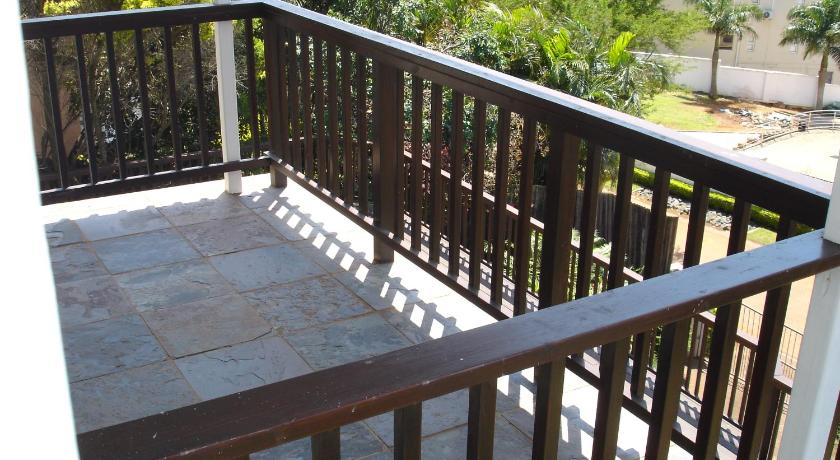 a wooden deck with a wooden fence and a balcony, Bella Vista Guest House in Durban