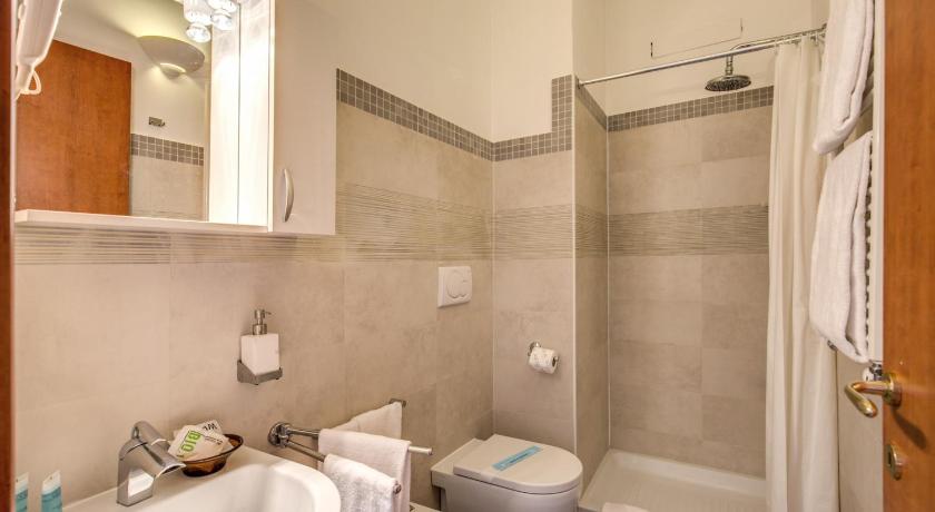 a white toilet sitting next to a bath tub, Domus Caracalla in Rome
