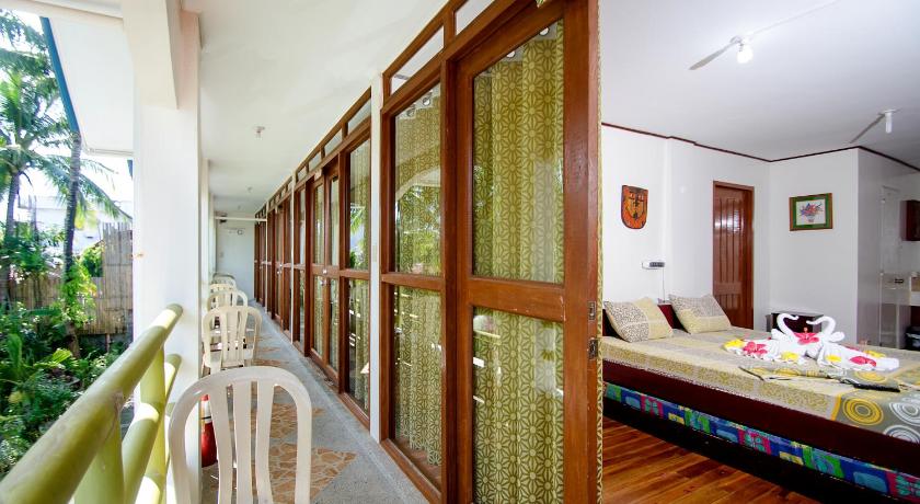 a room with a bed, a chair, and a window, RedDoorz Plus @ Secret Garden Boracay in Boracay Island