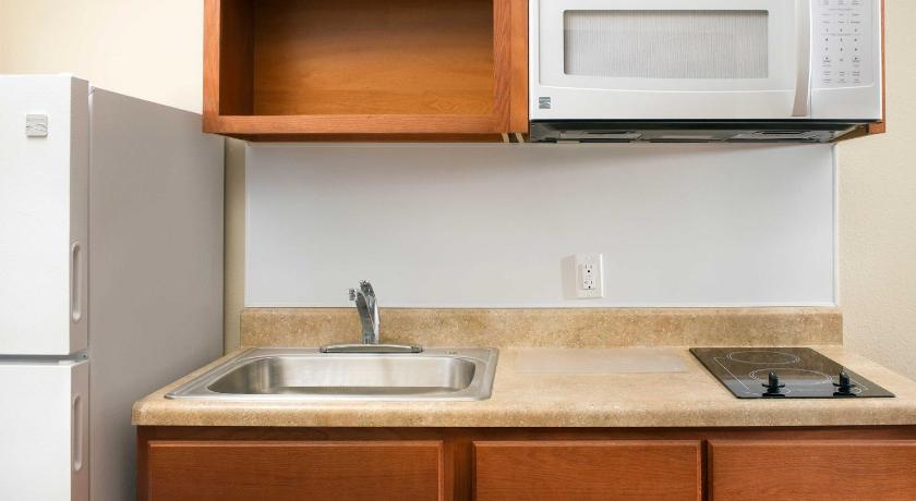 a kitchen with a sink and a microwave, WoodSpring Suites Dickinson in Dickinson (ND)