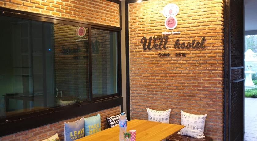 a restaurant with a sign on the side of the building, Warm Well Hostel in Kanchanaburi
