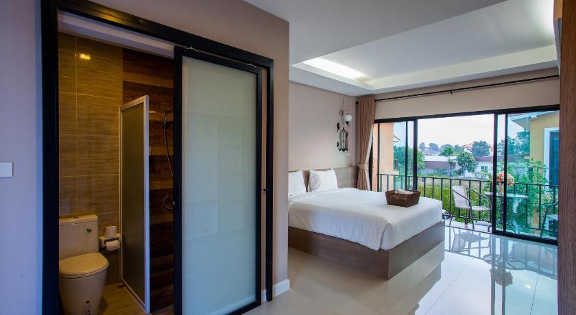 a hotel room with a bed and a shower, Sata House Boutique Resort in Nakhonratchasima