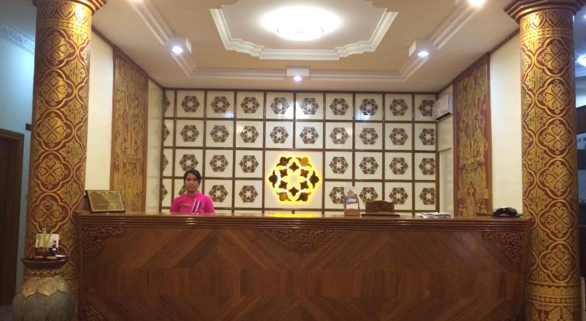 a large ornate room with a large window, Bagan Umbra Hotel in Bagan